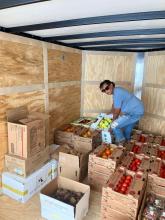 Susan Miller with boxes of produce